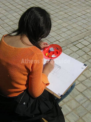 Art student working in front of the National Archaeological Museum in Athens