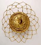 Gold hair net. The medallion at the centre has a repousse bust of Artemis with her quiver. The wreaths encircling the bust are adorned with garnet and emeralds. From the "Karpenisi Treasure". 3rd century BC - National Archaeological Museum Athens