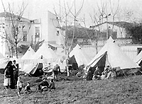Refugees camp on the outskirts of mid-war Athens